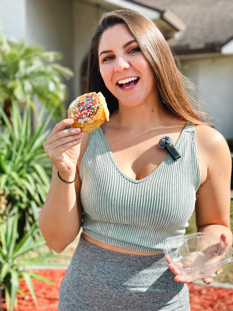 myplantbasedfriend holding a high protein cinnamon roll