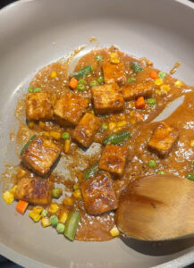 coating crispy tofu with peanut sauce